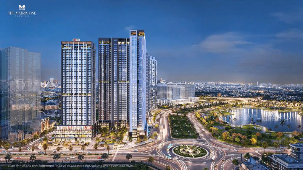 Vị trí The Matrix One Premium - Chủ đầu tư MIK Group 4 Hình ảnh toàn cảnh The Matrix One Premium, với 2 tòa tháp hiện đại có cửa sổ sáng đèn vào lúc hoàng hôn, xung quanh là vòng xoay nhộn nhịp, cây xanh tươi tốt và một hồ nước yên bình, với khung cảnh thành phố Hà Nội ở phía xa.